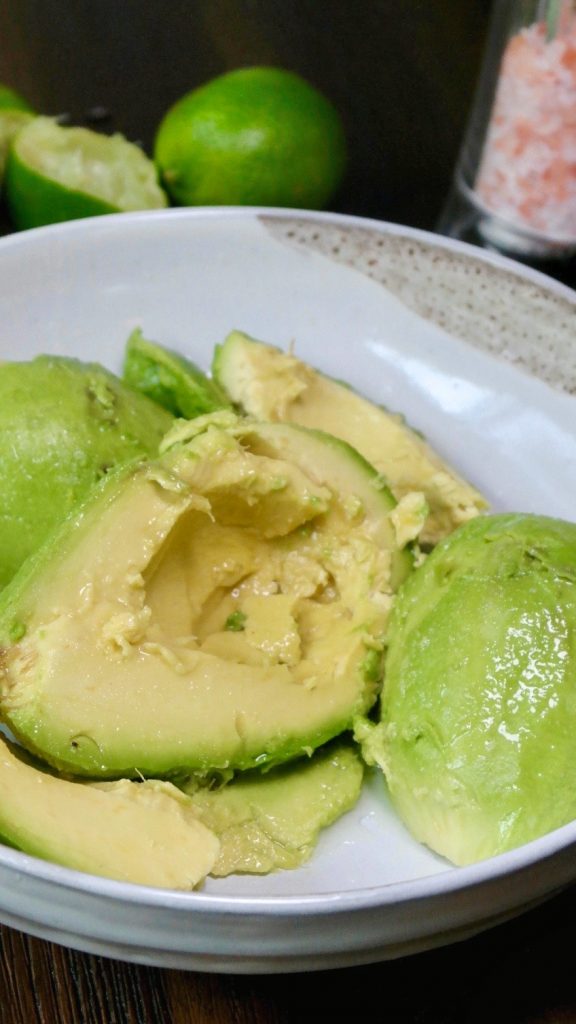 Fresh avocados in a cream bowl for guacamole