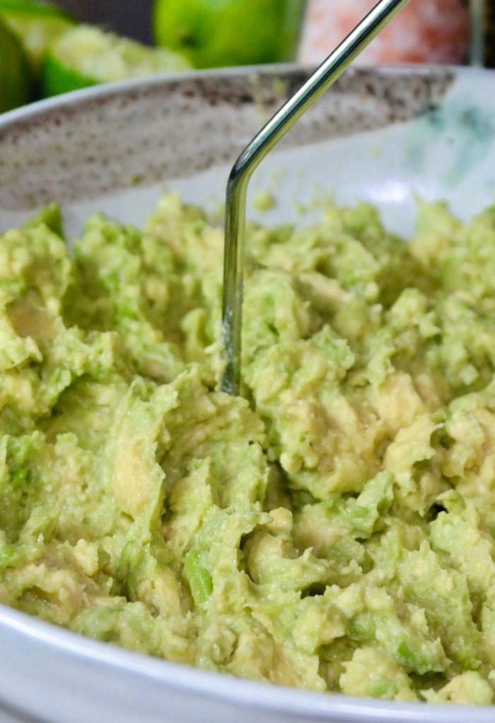 Mashed guacamole in a cream bowl for guacamole dip