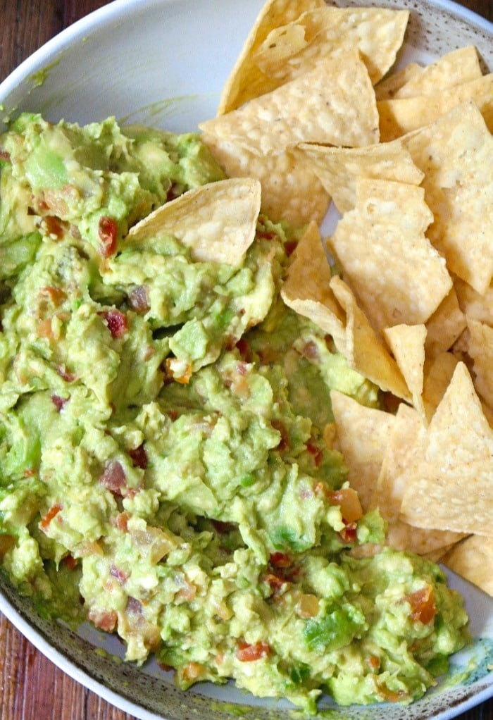 Easy guacamole recipe with prepared salsa in a white bowl.