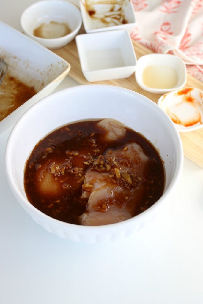 Marinating chicken breasts ahead of grilling them for a grilled chicken salad recipe. 