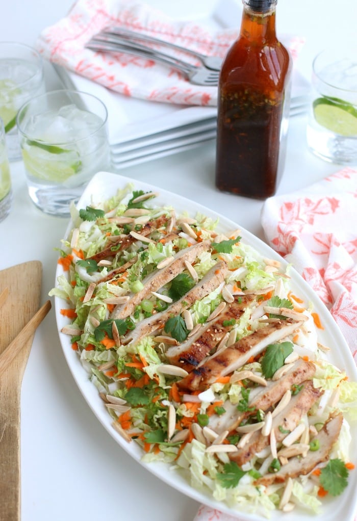 A grilled chicken salad recipe with  fresh ingredients like cabbage, carrots and green onions. Asian inspired flavors using ginger and roasted sesame seeds are added with the Asian salad dressing.