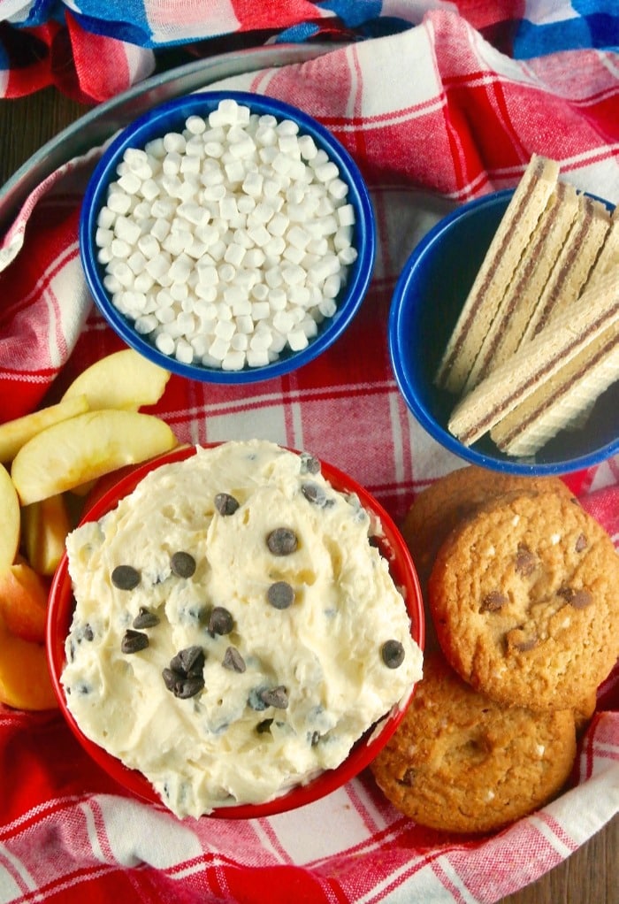overhead view of chocolate chip dip with fruit and cookies