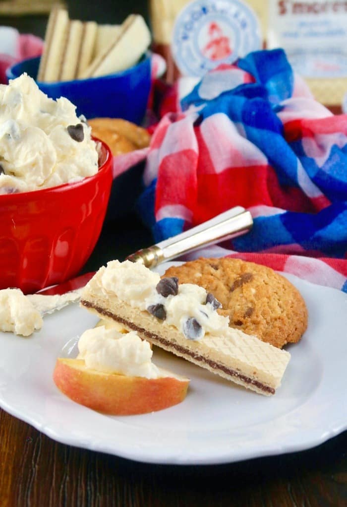 chocolate chip dip recipe with cookies and apple slice on a white plate