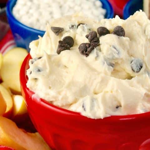 cream cheese dip with chocolate chips in a red serving bowl