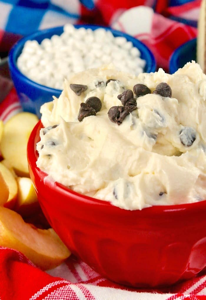 cream cheese dip with chocolate chips in a red serving bowl