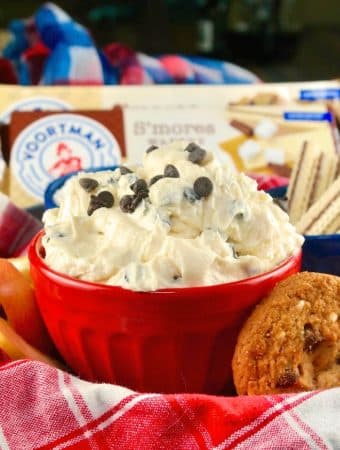 Red bowl with chocolate chip with cream cheese for dipping cookies