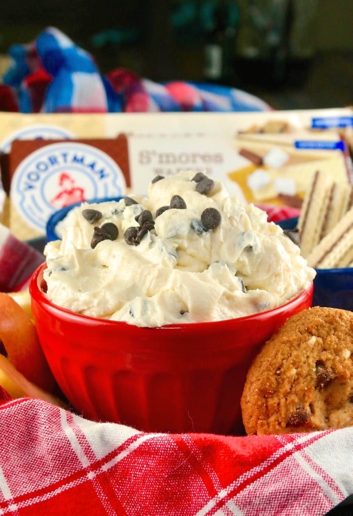 Red bowl with chocolate chip with cream cheese for dipping cookies