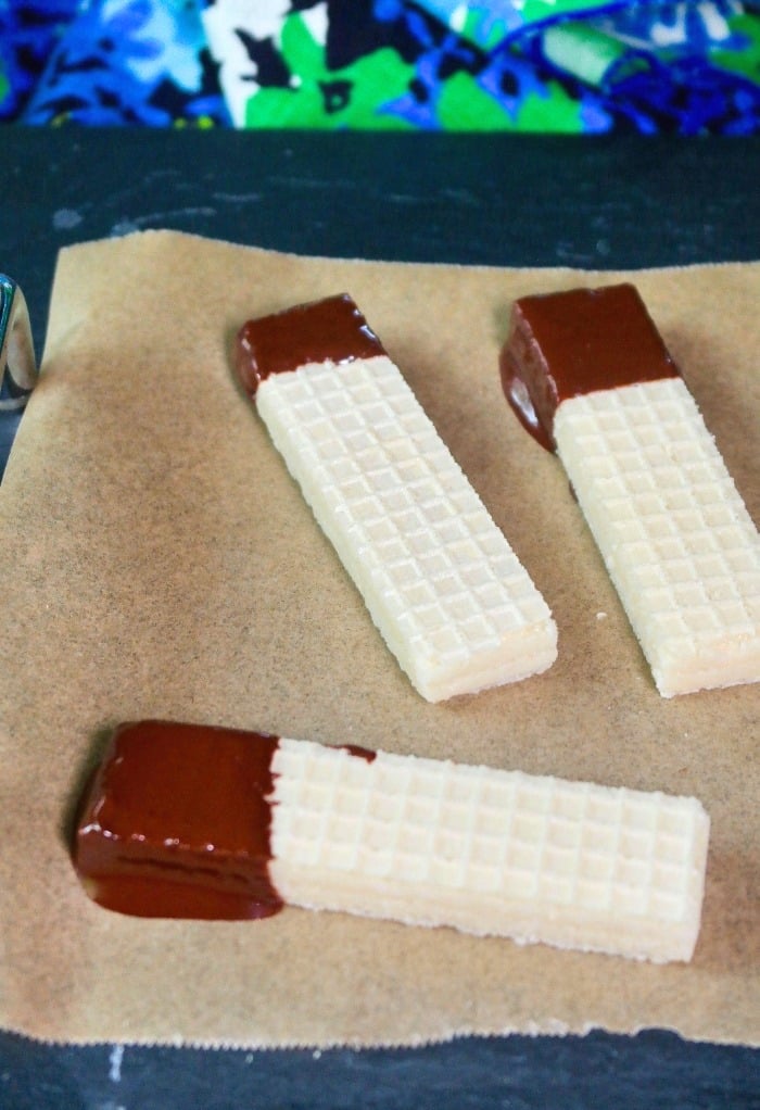 chocolate dipped wafers on a baking sheet