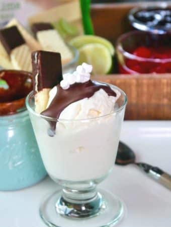 vanilla ice cream in a clear dish with chocolate on top