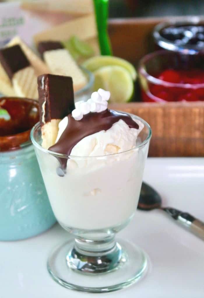 vanilla ice cream in a clear dish with chocolate on top