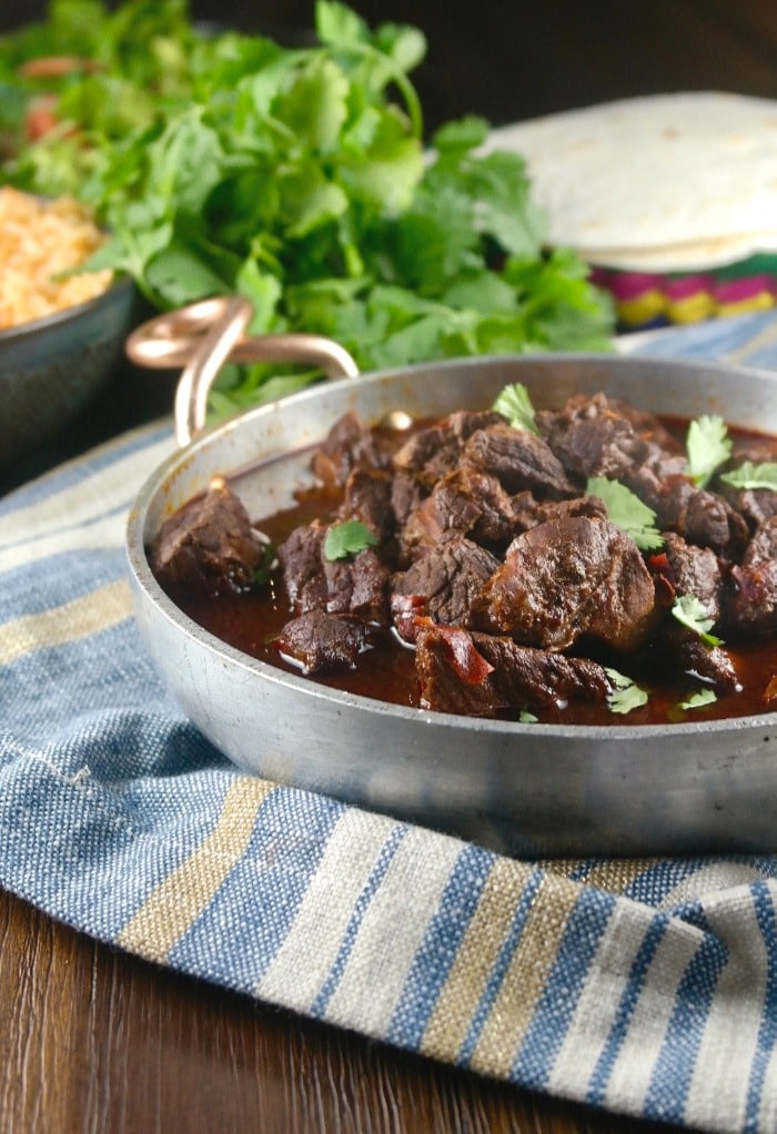 Mexican stew, chili colorado in a tin serving bowl