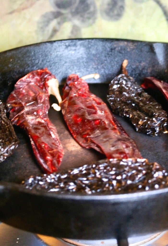 toasting chili pods in a iron skillet