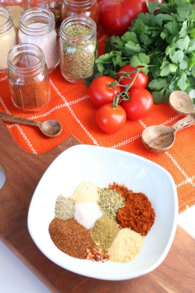 Individual spices on a table for taco seasoning recipe.