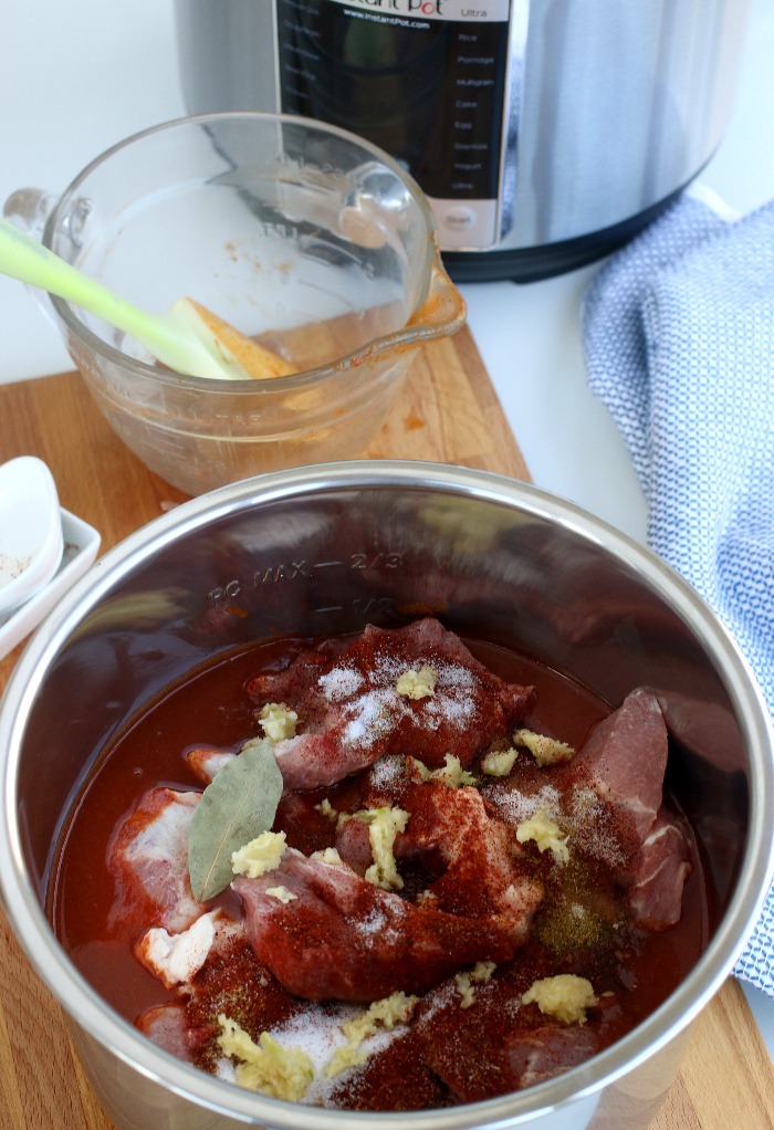 Pork shoulder, spices and sauce added to a Instant Pot soup recipe.