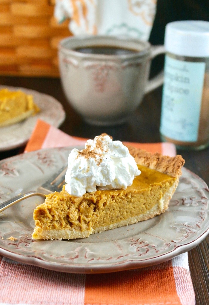 Slice of low carb pumpkin pie on a tan plate