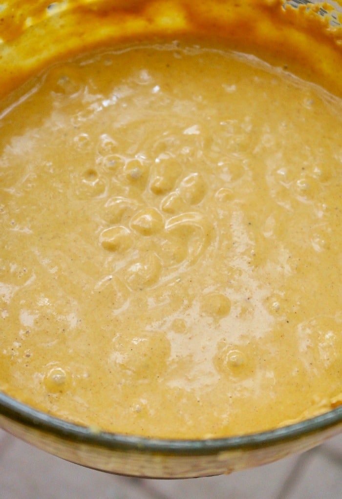 all the ingredients for pumpkin pie in a mixing bowl