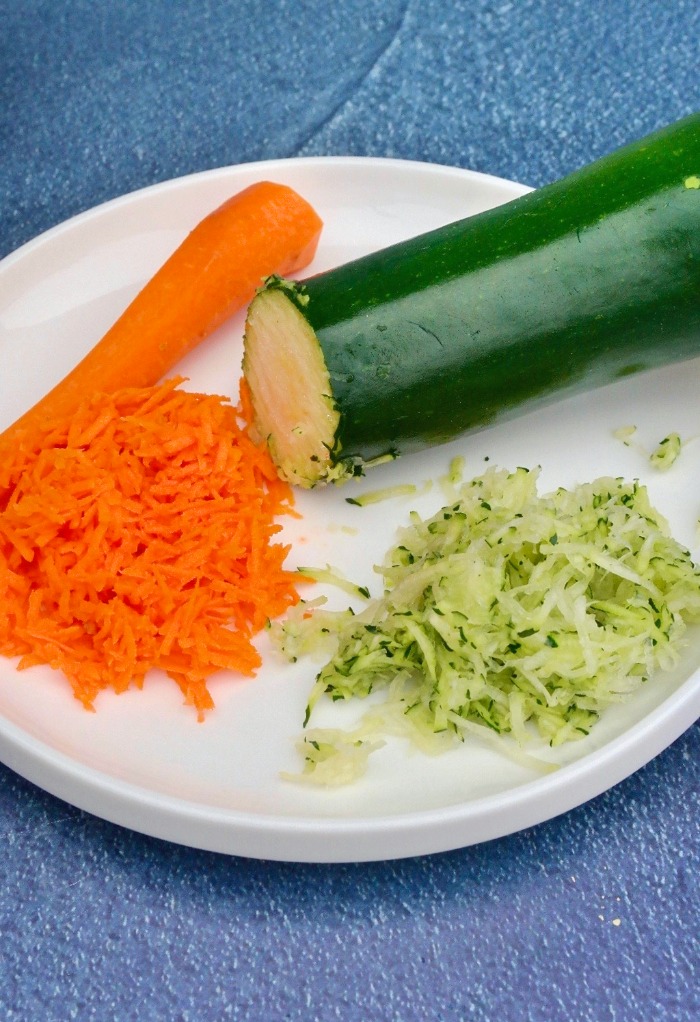 Shredded carrots and zucchini on a white plate
