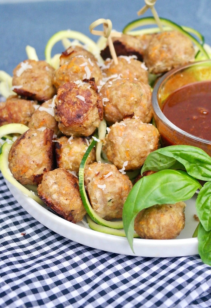 Plate of turkey meatball appetizer with sauce on the side.