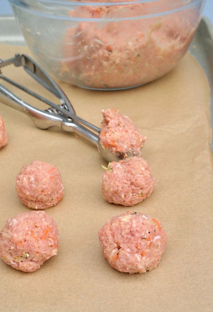 Baking sheet of uncooked turkey meatballs