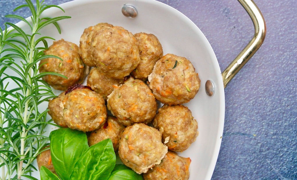 Healthy turkey meatballs on a white serving dish.