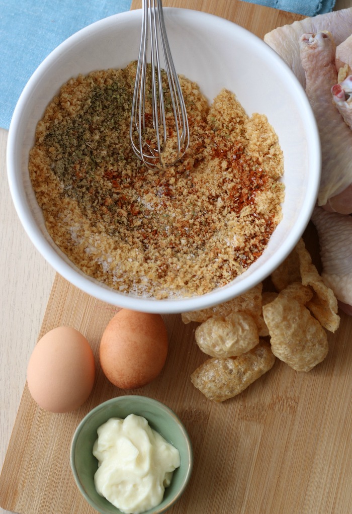 Mixing the spices into the pork rinds before using pork rinds on keto fried chicken. 