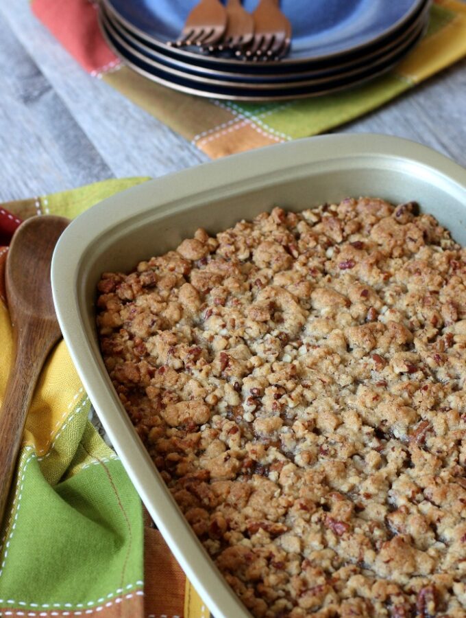 Perfectly baked sweet potato casserole with pecans on top ready to be scooped out.