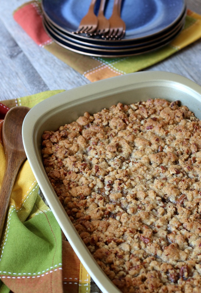 Perfectly baked sweet potato casserole with pecans on top ready to be scooped out.