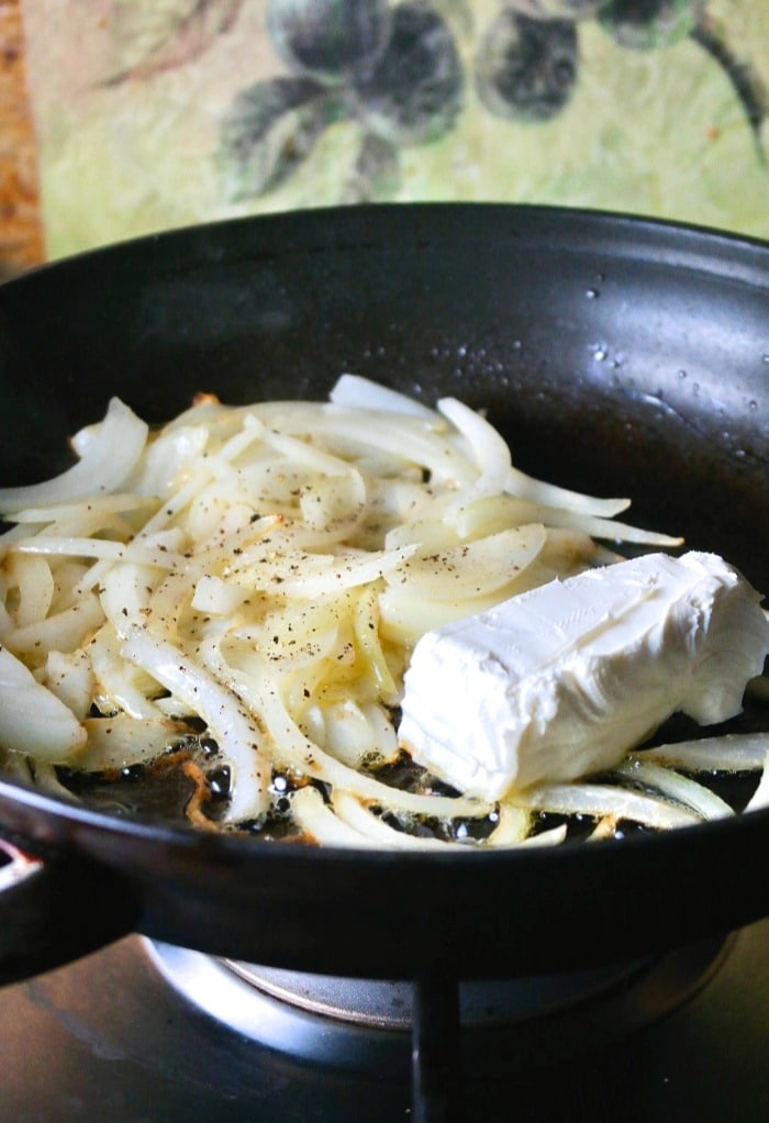 Sautéed onions for green bean casserole in a skillet.