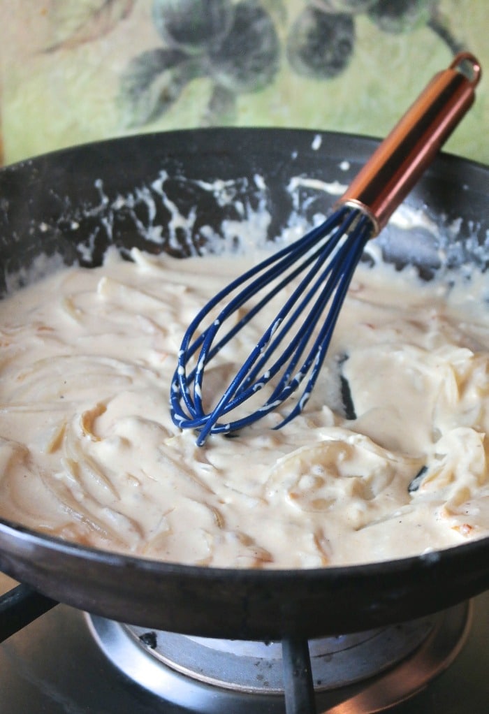 Mix homemade creamy sauce for low carb green bean casserole.