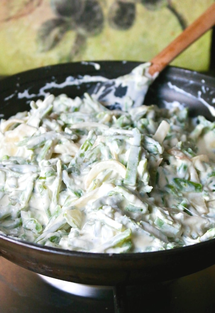 Mix together green beans and creamy sauce until coated.