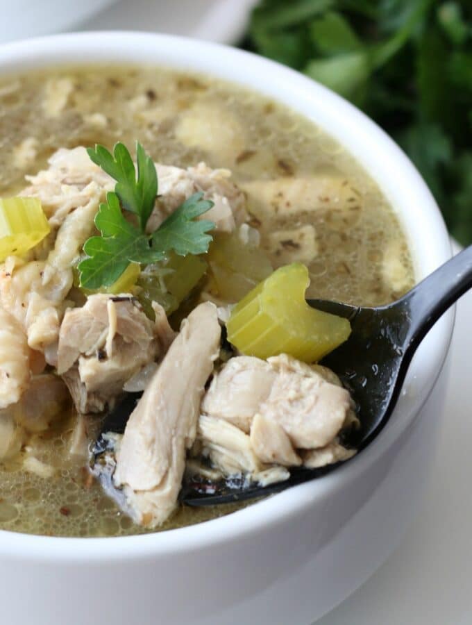 White bowl filled with chicken soup