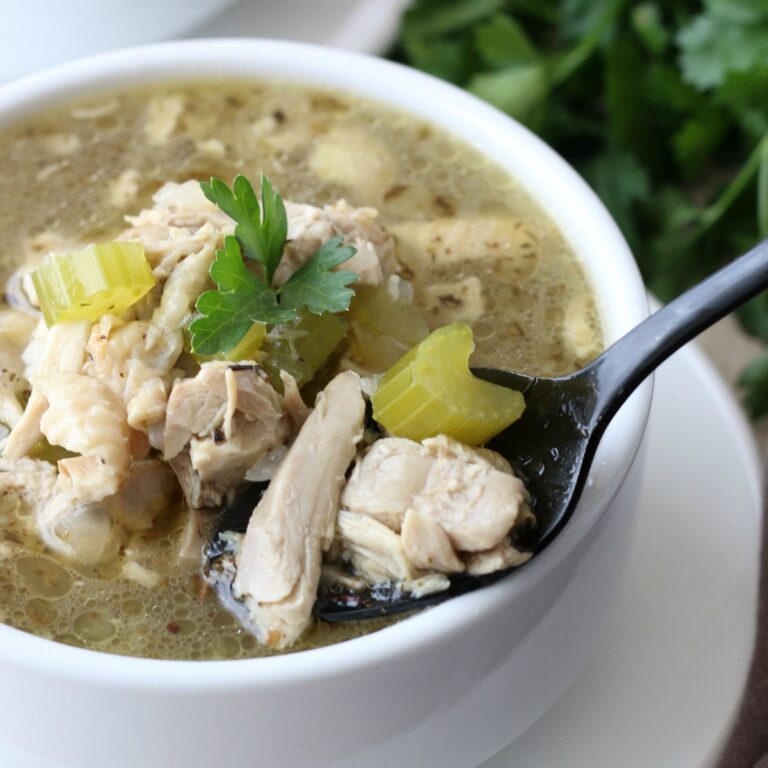 White bowl filled with chicken soup