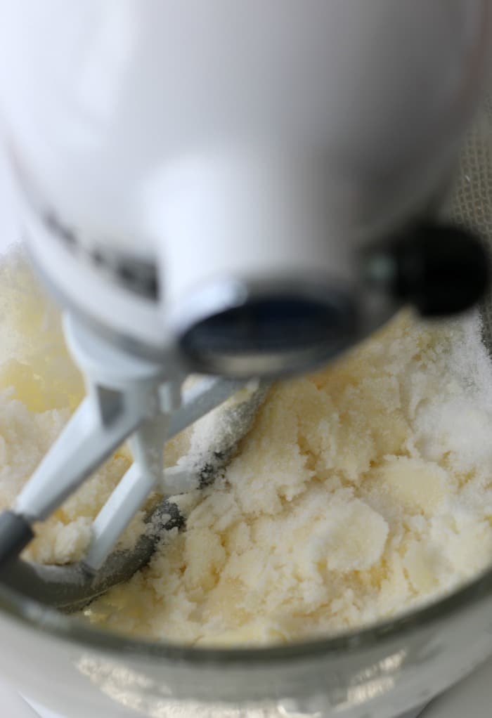 Dry ingredients for the lemon ricotta cookies are being added to the stand mixer. 