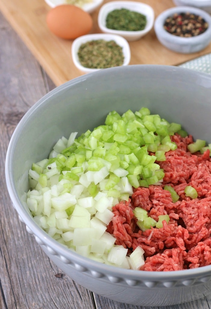 This image shows the base of the keto meatloaf with meat and veggies in a bowl ready to be seasoned. 