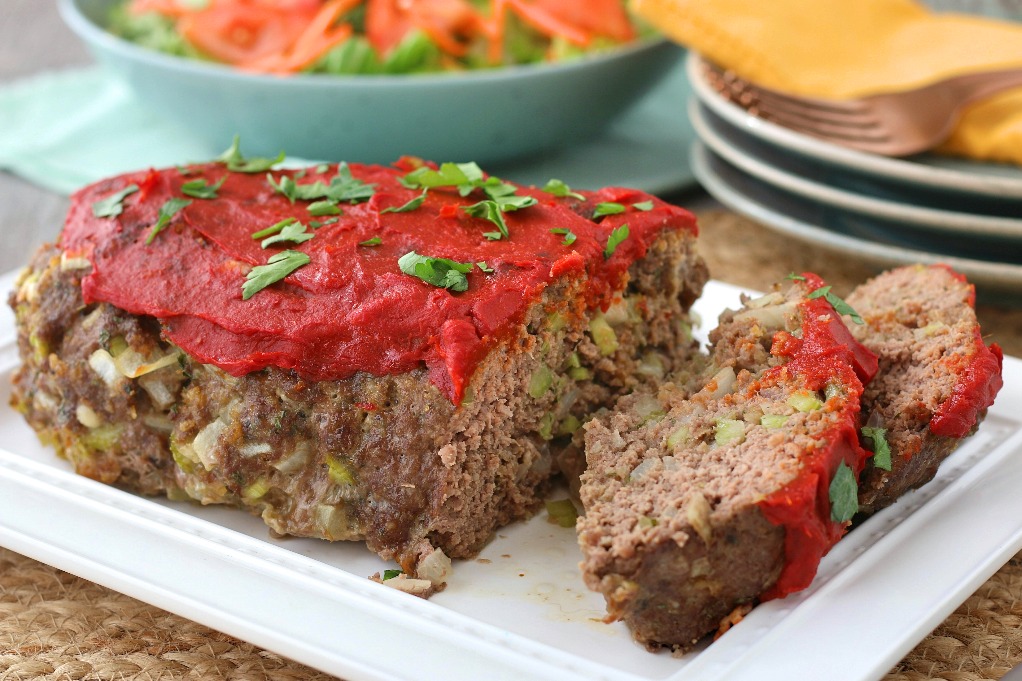 A horizontal view of the finished meatloaf recipe on the table ready to be served.