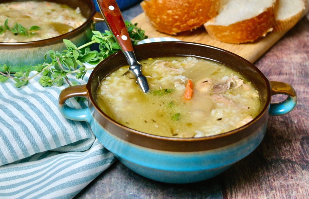 Blue bowl filled with turkey and rice soup