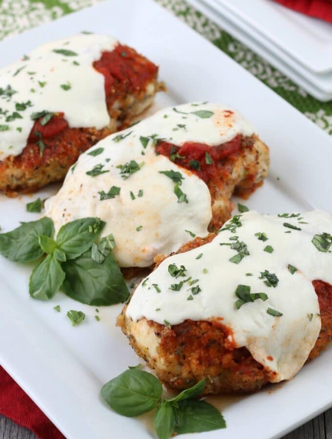 Keto chicken parmesan on a white serving platter.