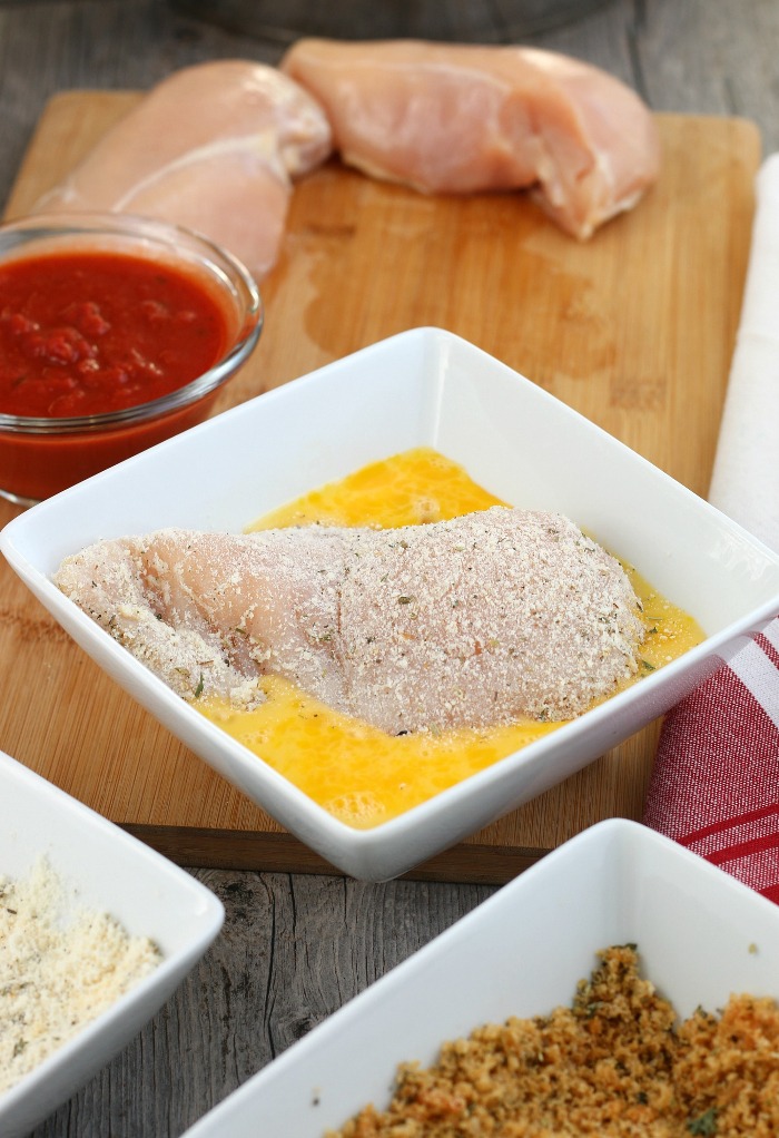 Next the keto parmesan crusted chicken goes into the egg wash.