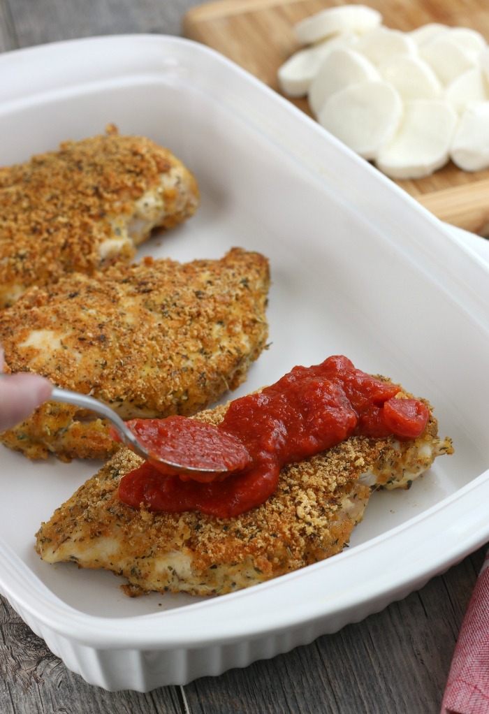 What would chicken parmesan be without marinara be without the sauce? Here we see it being added to the keto chicken parmesan!