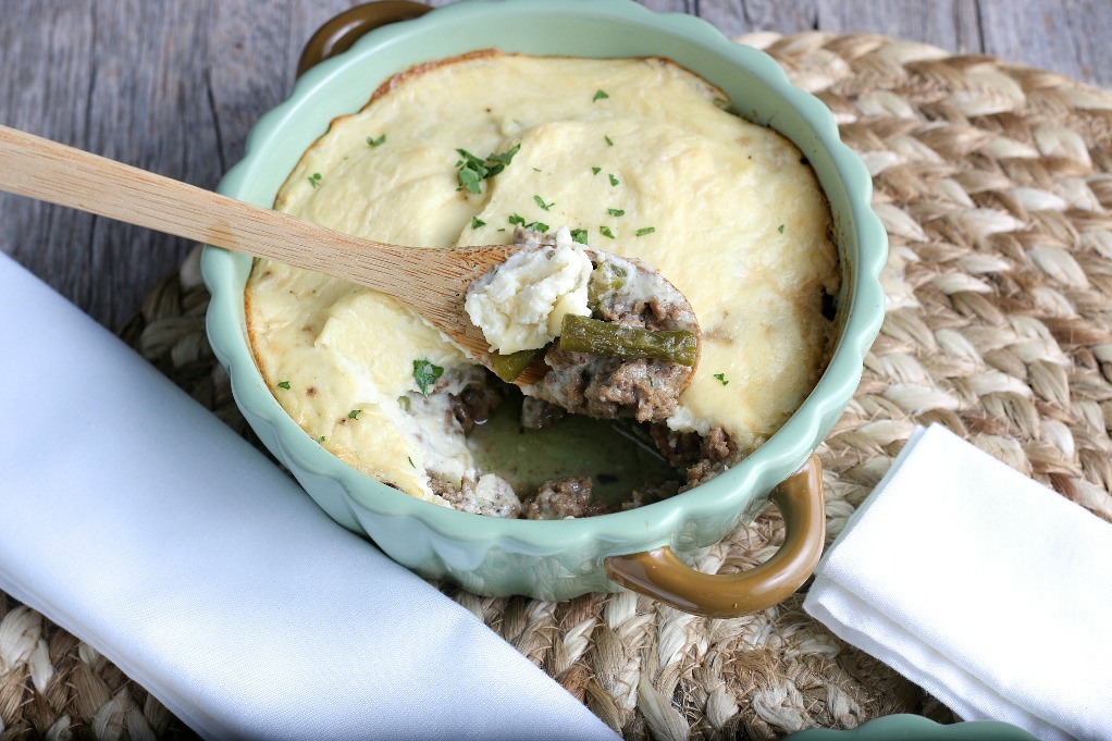 Another horizontal shot of the completed cauliflower shepherds pie with a scoop ready to be served. 