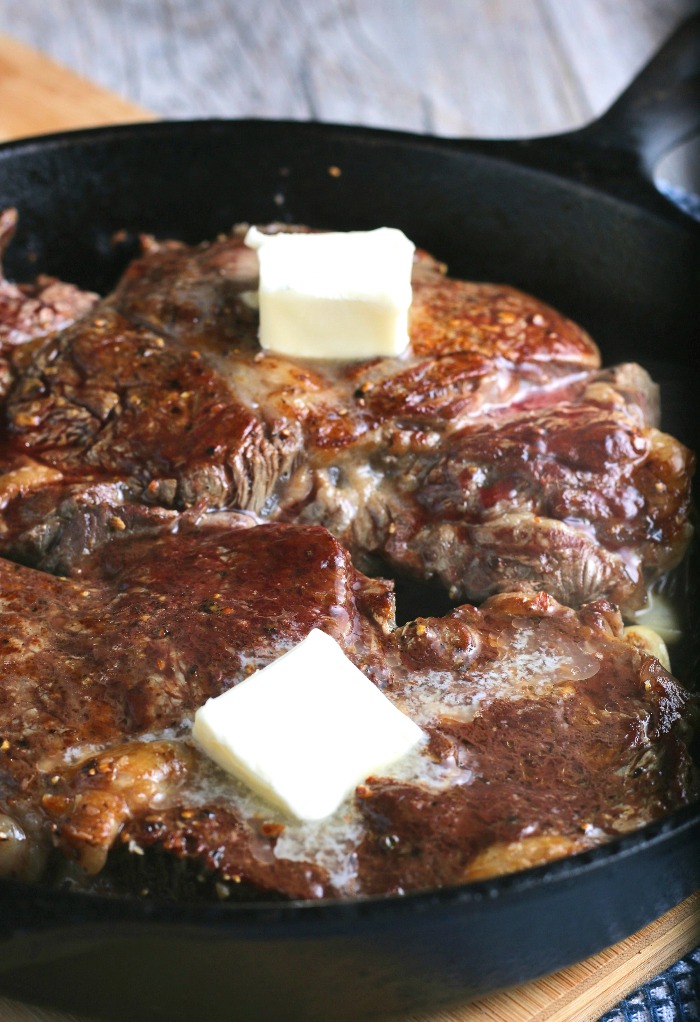 Adding butter when learning how to cook a steak in a frying pan is a great way to add flavor and keep the steaks from drying out.