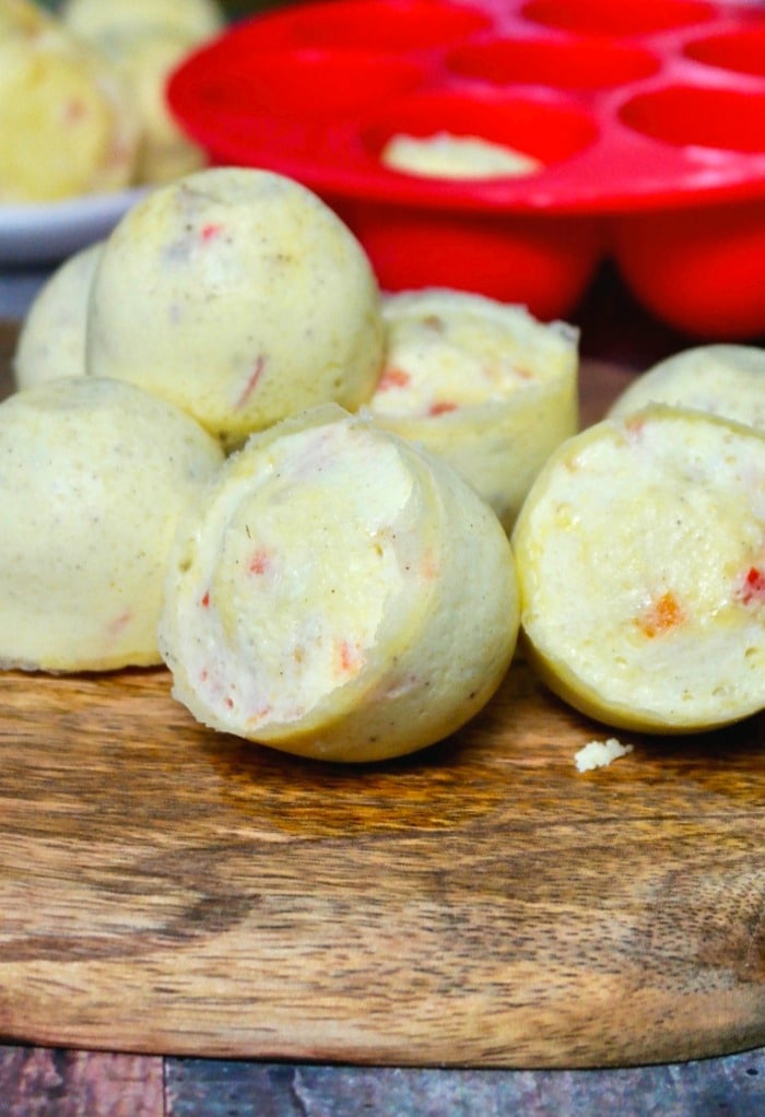 Cooked copycat egg bites form Starbucks on a wooden platter.