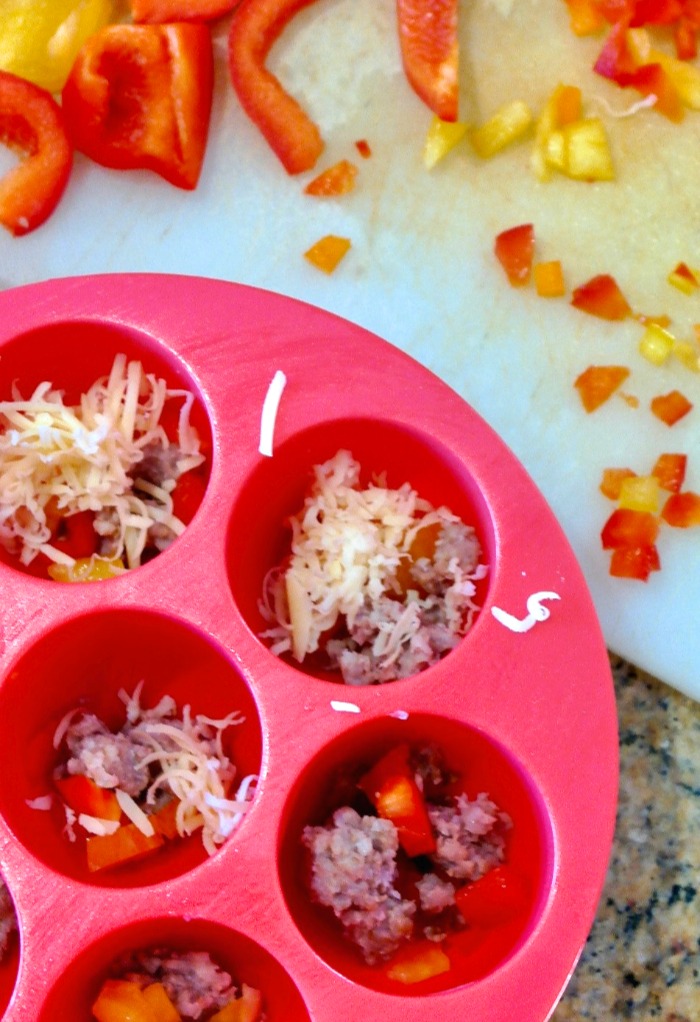 Filling silicone egg bites mold with ingredients to cook in an Instant Pot.