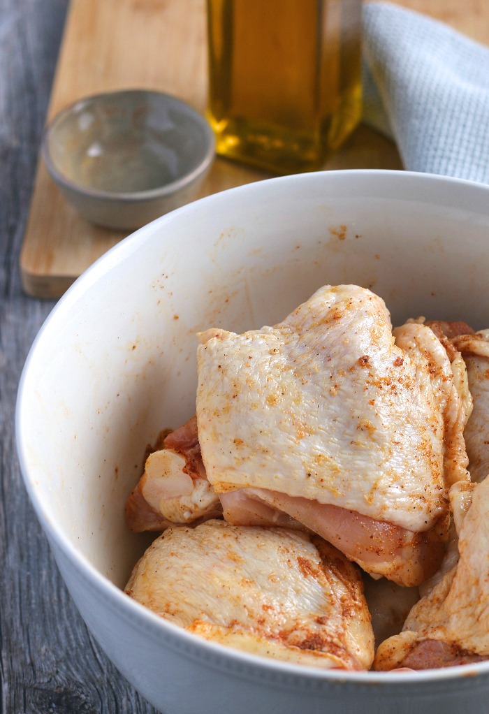 Once the chicken thighs are coated with seasoning they are ready to be put into the skillet!