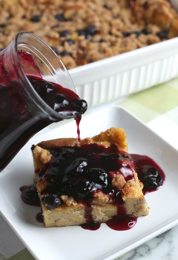 This image shows the blueberry topping being added to the french toast bake. The most delicious addition!