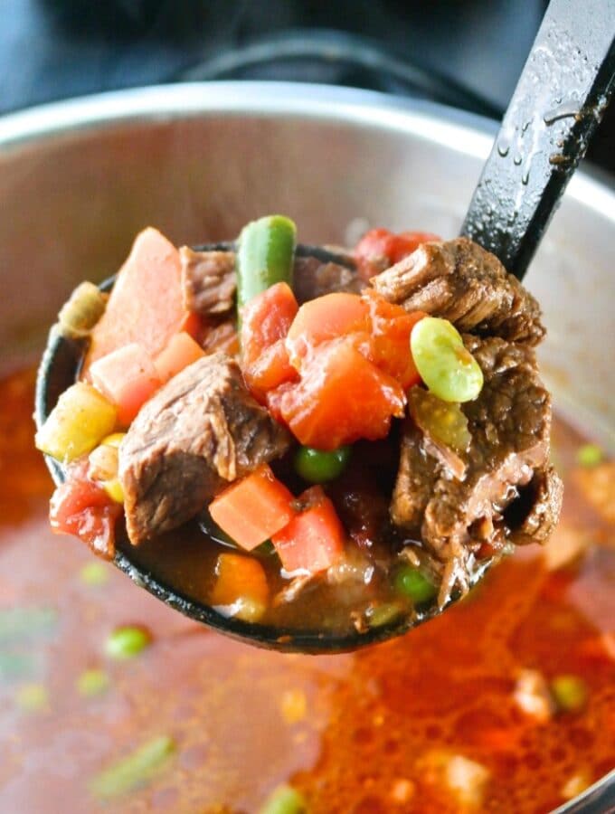 Spooning a ladle of soup from the Instant Pot.