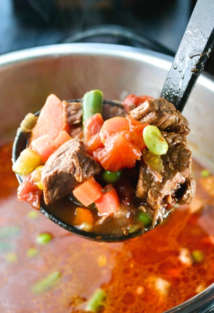 Spooning a ladle of soup from the Instant Pot.