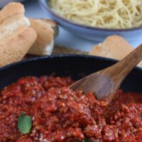 Here we see a spoon digging into the delicious and ready to eat meat sauce recipe.