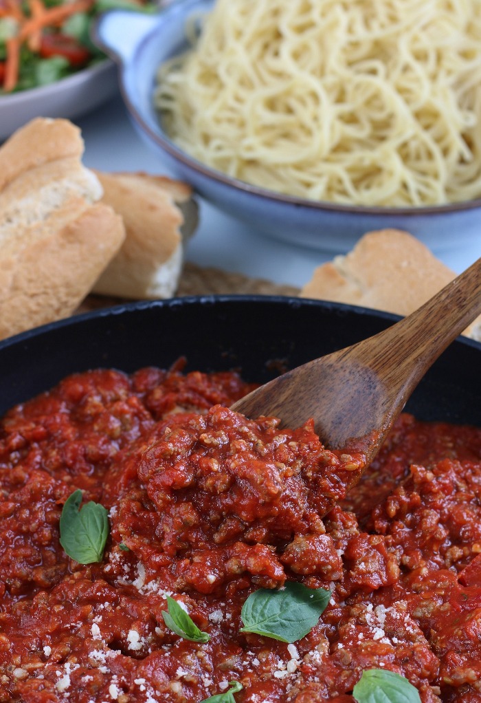 Here we see a spoon digging into the delicious and ready to eat meat sauce recipe. 