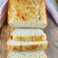 Sliced loaf of healthy banana bread on a cutting board